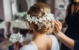 Bridal hairstylist in East Lyme Connecticut creating an elegant wedding hairstyle for a bride during wedding day preparation at a salon